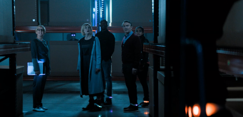 The Doctor and friends, complete with tracking devices, get a tour of their new workspace.